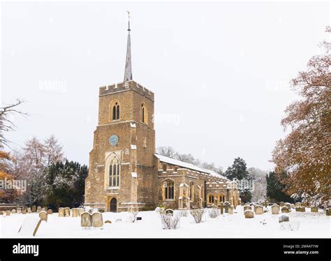traditional english village church covered in snow st andrews church much hadham