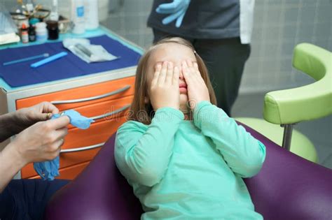 Little Scared Girl Sitting In Chair In Dentist Doctor Office Kidchild