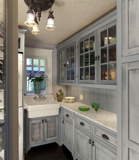 This kitchen by designer tom scheerer encompasses to many current kitchen trends—open shelving, cement tiles, bare wood. distressed gray with beadboard and hints of gray in ...