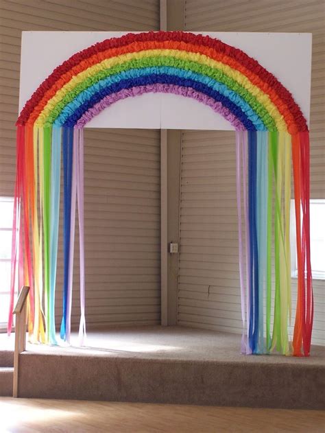 A Rainbow Arch Is Decorated With Streamers And Ribbons