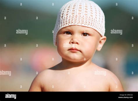 Outdoor Summer Portrait Of Caucasian Baby Girl In White Hat On The