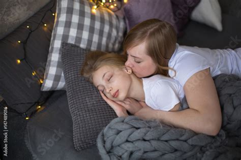 Mum Embraces A Sleeping Babe Teenager Stock Photo Adobe Stock