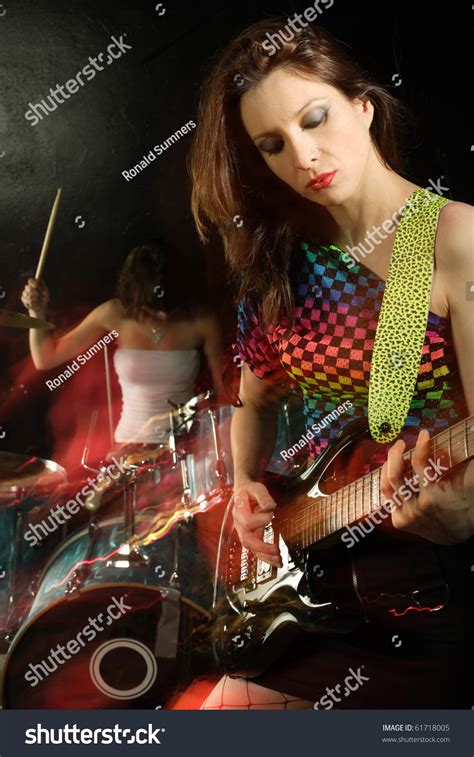 Photo Of A Female Guitarist Playing On A Stage Shot With Strobes And
