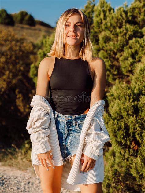 Portrait Of Beautiful Woman In Shorts Posing Outdoor Stock Photo