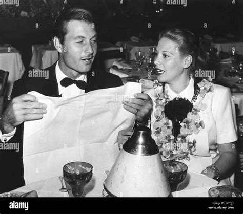 george montgomery left and his wife dinah shore at a mocambo party for walter winchell ca