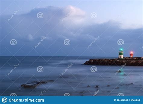 Lighthouses Surrounded By The Sea Under The Cloudy Sky In The Evening