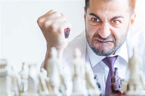 Businessman Playing Chess And Getting Angry Stock Photo Download