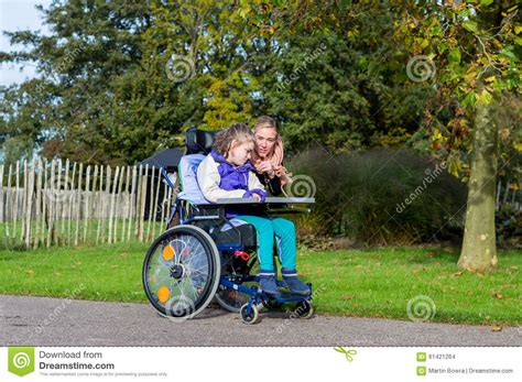 Disabled Girl In A Wheelchair Relaxing Outside Stock Photo