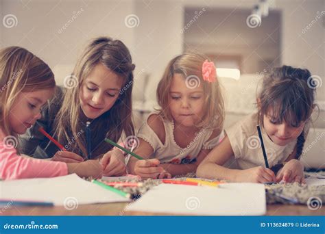 Four Girls Lying On The Floor Stock Image Image Of Book Educate