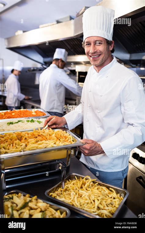 Chef Standing At Serving Trays Of Pasta Stock Photo Alamy