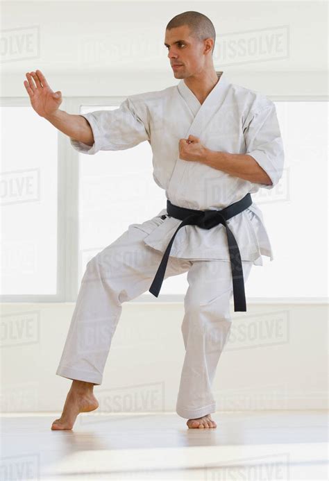 Hispanic Male Karate Black Belt In Fighting Stance Stock Photo Dissolve