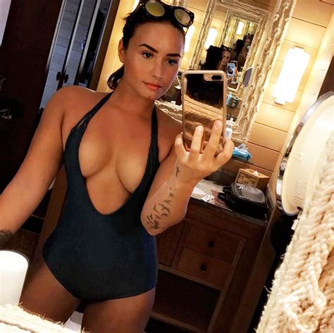 Demi Lovato Shows Off Her Cleavage In Plunging Swimsuit Pics