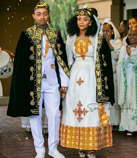 Clipkulture Couple In Habesha Kemis Attire With Black Ethiopian Embroidered Coats And Caps