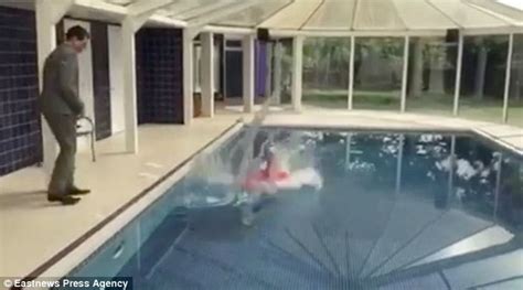 video shows estate agent being pushed in a swimming pool by colleague daily mail online