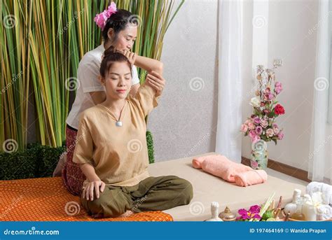 Thai Masseuse Doing Massage For Woman In Spa Salon Asian Beautiful Woman Getting Thai Herbal
