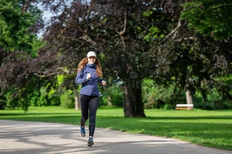 Young Woman Jogging In Park On Sunny Day Stock Photo Image Of Woman