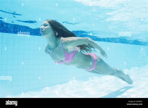 Mid Adult Woman Diving In Swimming Pool Underwater View Stock Photo