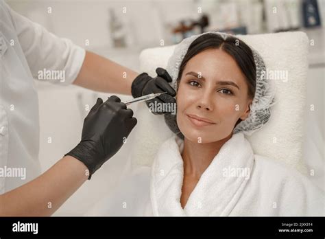 Cosmetologist Makes Rejuvenating Anti Wrinkle Injections On Face Of