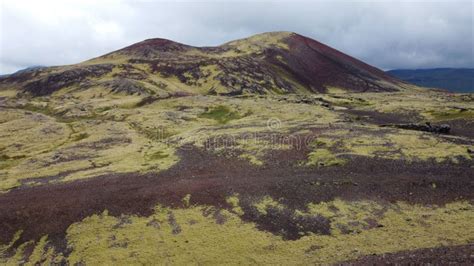 Green Moss Covered Volcanic Mountains And Black Lava Field In