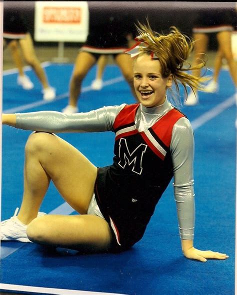 A Cheerleader Is Laying On The Floor With Her Arms Out And Legs Spread Wide