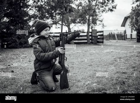 Young Boy Loading The Rifle Stock Photo Alamy