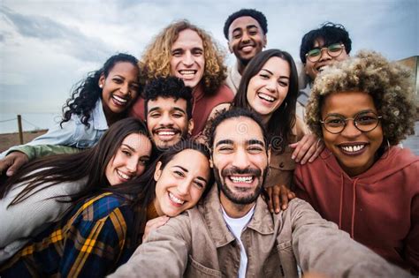 Multiracial Young Group Of Happy People Taking Selfie Together Stock