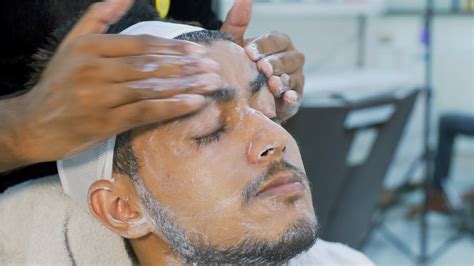 A Young Indian Man Getting Facial Cosmetology Procedure In A B