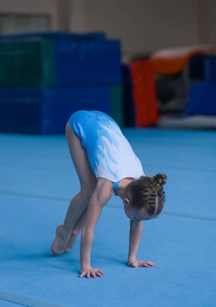 Premium Photo Young Girl Gymnast Performs An Exercise In The Gym