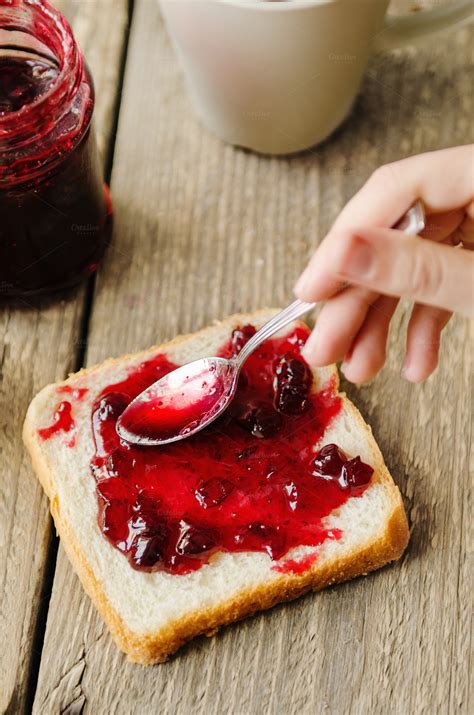 spread cranberry jam on bread ~ Food & Drink Photos on Creative Market