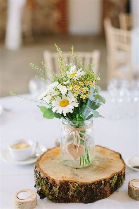 Rustic Wedding Table With Wood Slice With A Jar And A Wooden Heart And