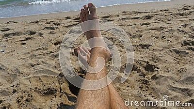 Legs Of Man Lying On Beach Near The Sea Pov Stock Video Video Of