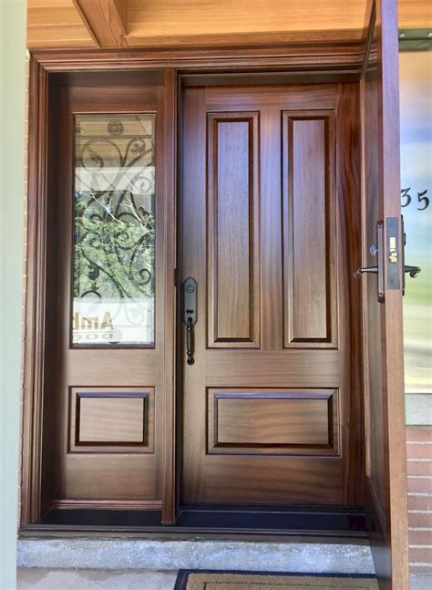 A Wooden Door With Two Sidelights And Glass Panels On The Front
