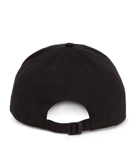 JW Anderson black x MGM Carrie Tiara Baseball Cap | Harrods UK