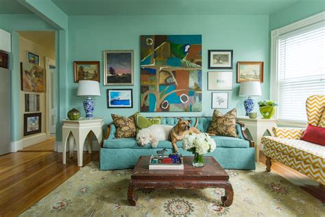 Bright Teal Blue Living Room Walls And Tufted Sofa With Art Gallery