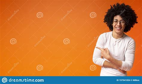 Awesome Black Guy In Glasses Pointing Away At Copy Space Stock Photo