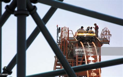 Texas Officials Help Riders Disembark The Titan Roller Coaster July