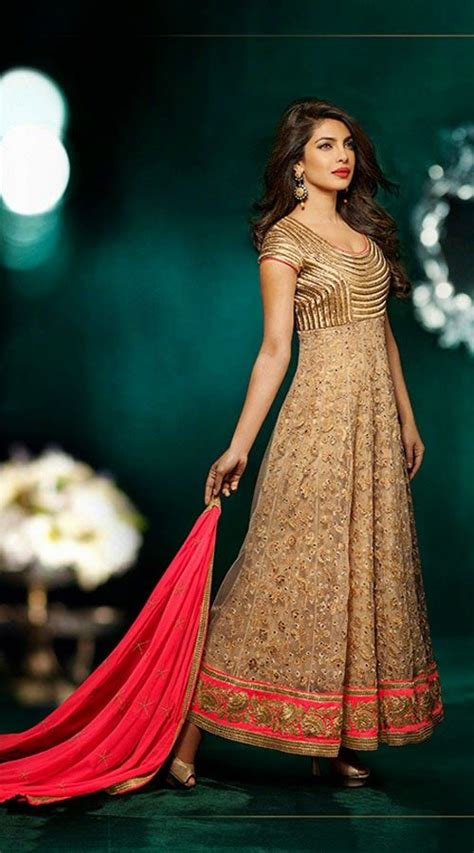 Bollywood Actress Priyanka Chopra Wearing This Beige Net Anarkali Suit Which Is Adorned With