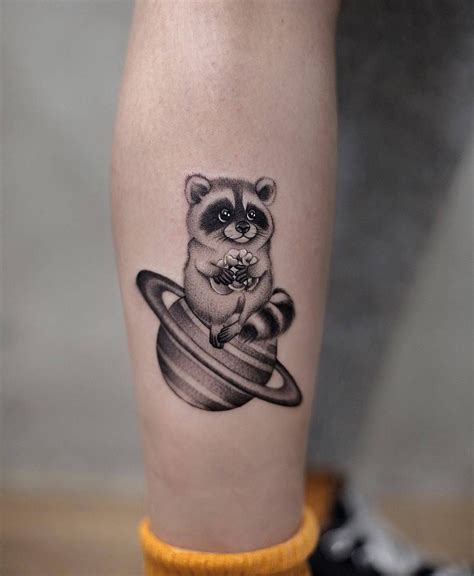 cute-minimalist-tattoo-by-akiwong-raccoon-tattoo,-minimalist-tattoo,-saturn-tattoo