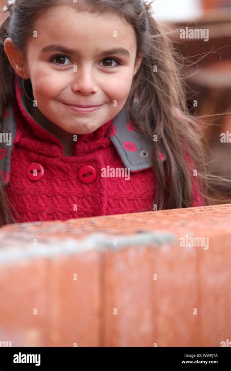 Little Girl Stood By Brick Wall Stock Photo Alamy