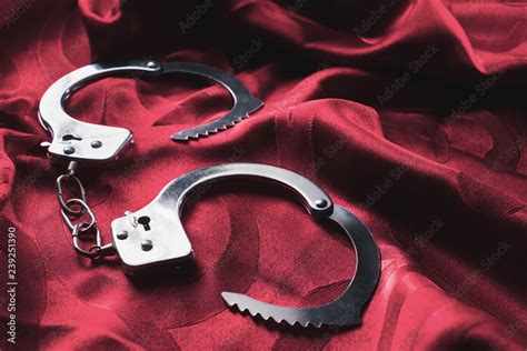 Kinky Handcuffs On The Bed Sheets Stock Photo Adobe Stock