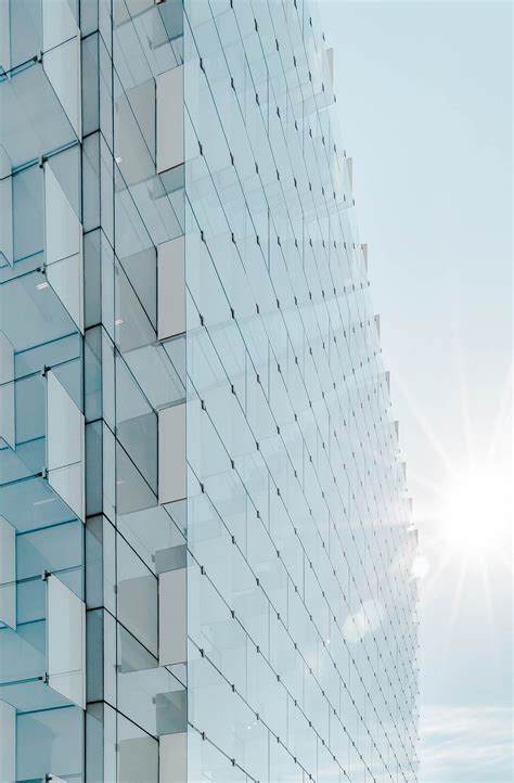 Free Photo Glass Facade Of Modern Office Building With Glare Reflection