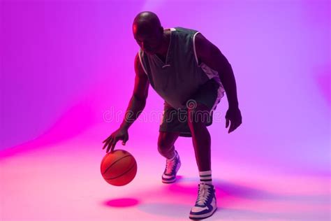 Image Of African American Basketball Player Bouncing Basketball On Neon