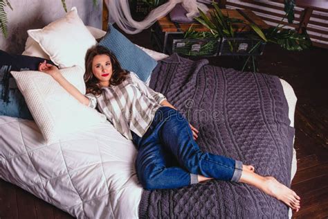 Beautiful Young Woman Resting In Bed Woman In Home Clothes Relaxes On Bed Home Comfort And