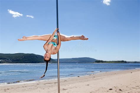 Acrobatic Performance Laughing Brunette Woman In Swimsuit On Pole For