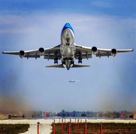 Klm Boeing 747 400 Taking Off From Runway 24r As A Boeing 777 300er Is