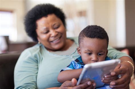 Grandmother Teaching Her Grandson How To Read Stock Photo