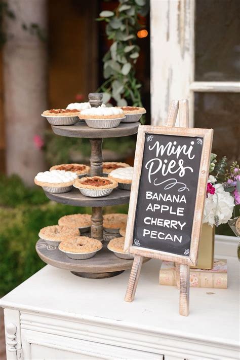 Mini Assorted Pies On Dessert Table Displayed On Wooden Trays For