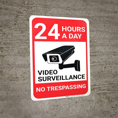 video surveillance 24 hours no trespassing with icon portrait wall sign