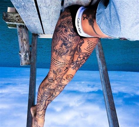 a person with tattoos on their legs and leg