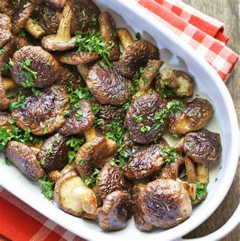 Cooked Mushrooms With Parsley In A White Dish On A Red And White